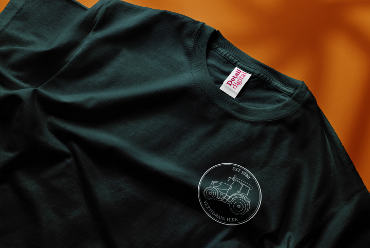 The Vertidrain Hire logo on a dark green t-shirt.