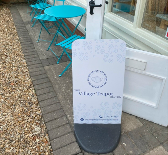 The Village Teapot pavement signs in front of the cafe building.